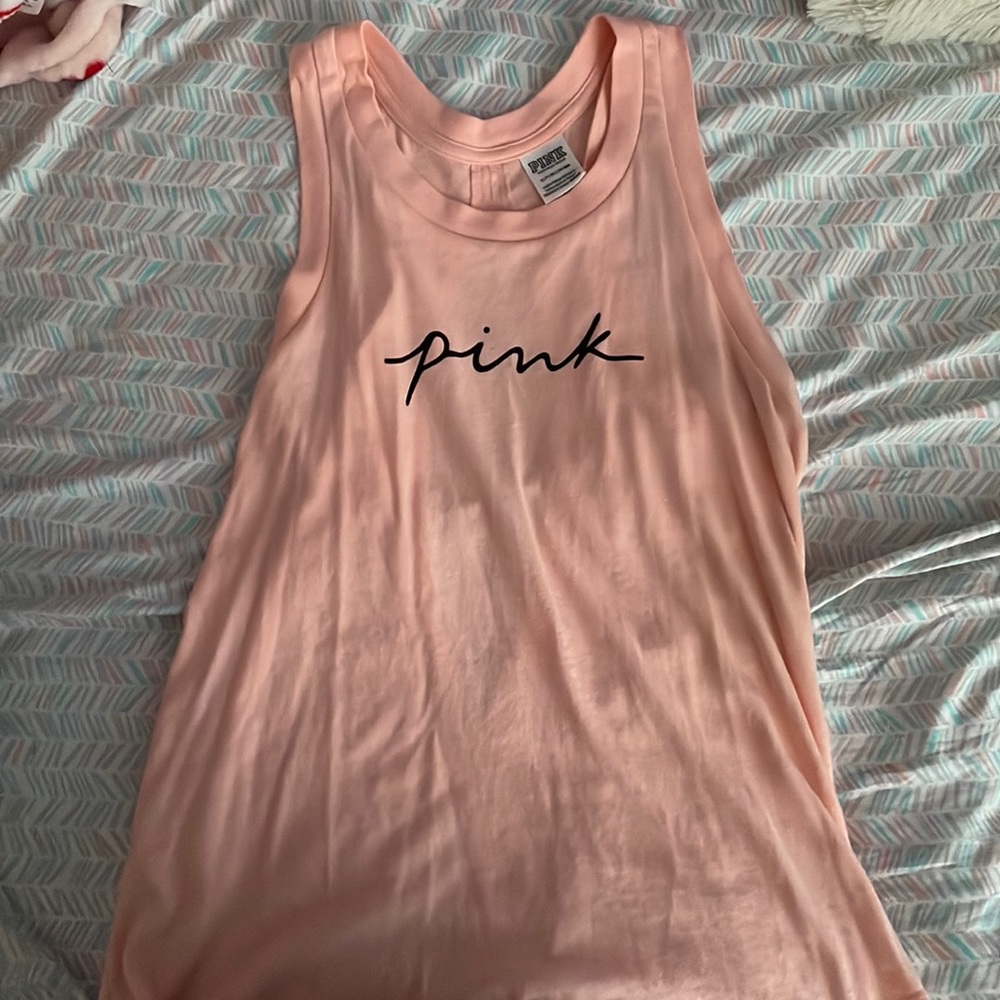 This is a peachy pink shirt from PINK. It is a size small.